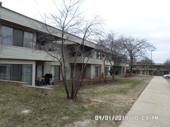 Front view of a two-story apartment building with balconies.