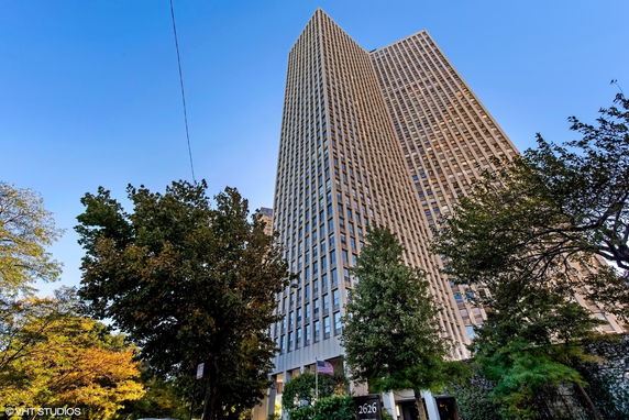 Front view of a tall modern skyscraper building.