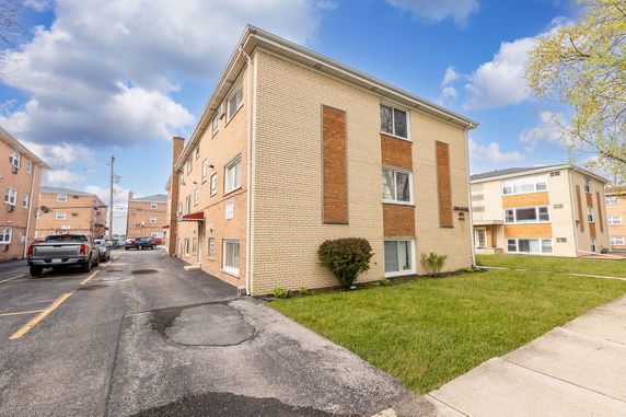Front view of a three-story brick apartment building.