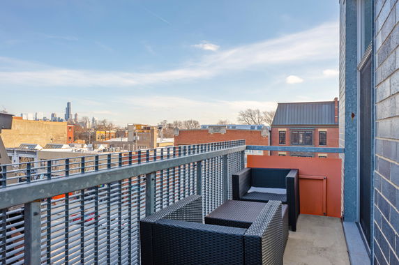 View from a balcony with cityscape in the background.