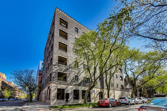 Front view of a multi-story building with brick exterior.
