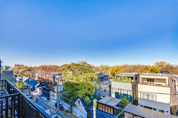 Panoramic view of surrounding residential area with multiple houses and trees.