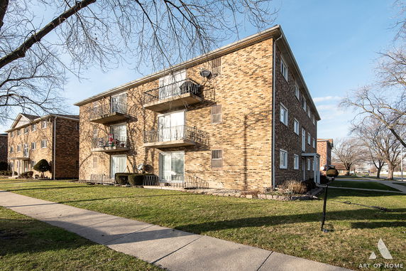 Front view of a multi-story brick apartment building.