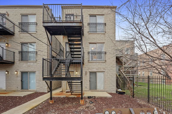 View of a multi-story building with exterior stairs and balconies.