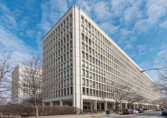 Front view of a large multi-story office building with uniform window patterns.