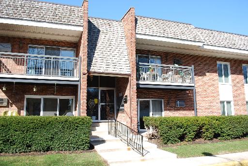 Front view of a two-story brick building with balconies.