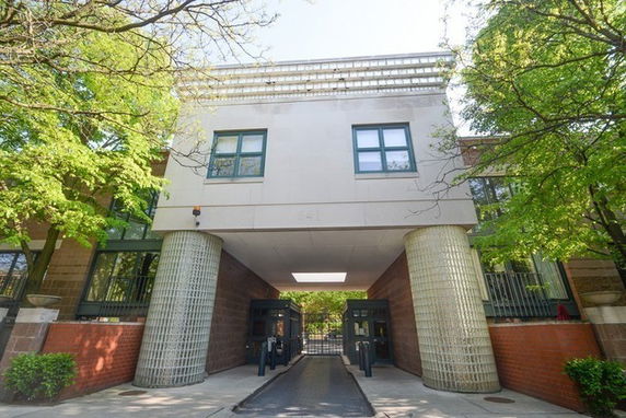 Front view of a building with large pillars and upper windows.