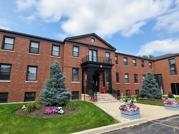 Front view of a two-story brick building with symmetrical windows and a central entrance.