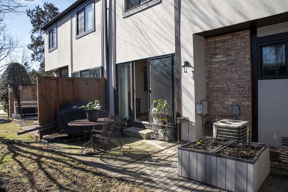 Rear view of a two-story house with patio area.
