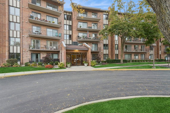 Front view of a multi-story residential building with balconies.