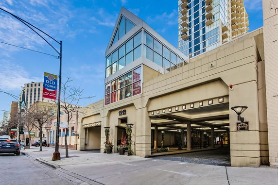 Front view of a multi-story building with large windows.