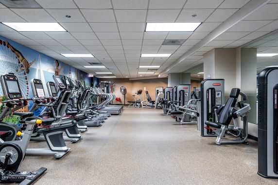 Interior view of a gym with workout equipment and exercise machines.