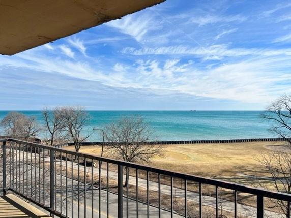 Panoramic view of the ocean from a building balcony.