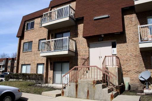 Front view of a multi-story brick building with balconies.