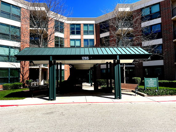 Front view of a multi-story building with a covered entryway.