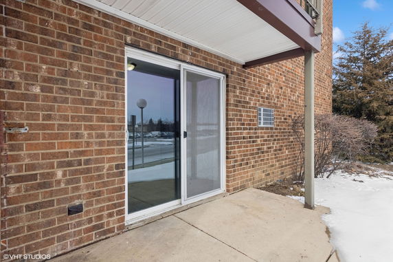 Exterior view of a brick building with sliding glass doors.