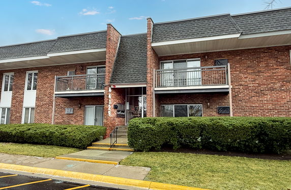 Front view of a two-story brick building with balconies.