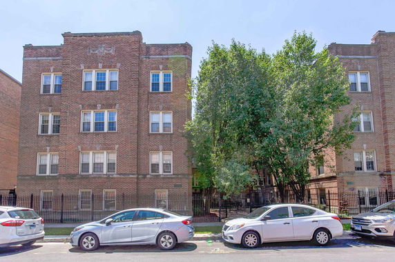 Front view of a multi-story brick apartment building.