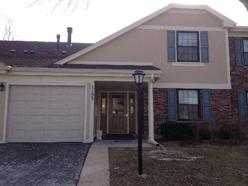 Front view of a two-story house with an attached garage.