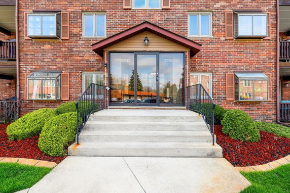 Front view of a multi-story brick building with a central entrance.