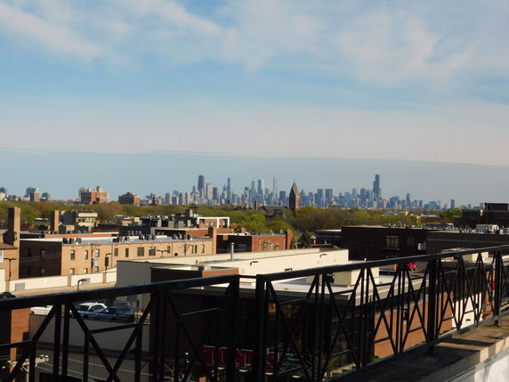 Panoramic view of an urban landscape with city skyline in the distance.