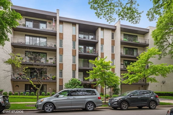 Front view of a multi-story apartment building with balconies.