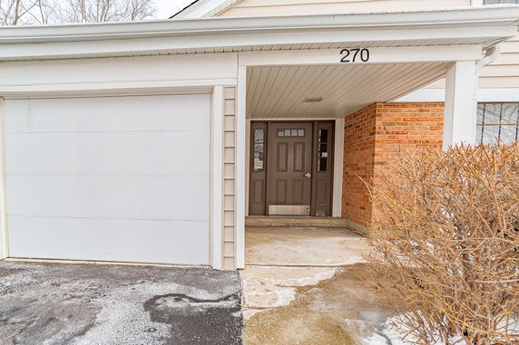 Front view of a house with a covered entrance and garage.