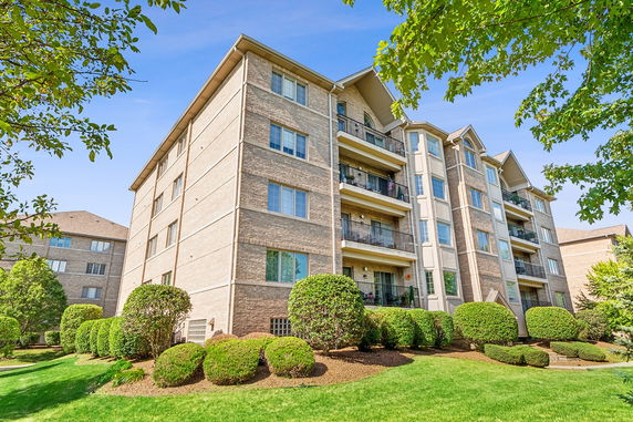 Front view of a multi-story apartment building with balconies.