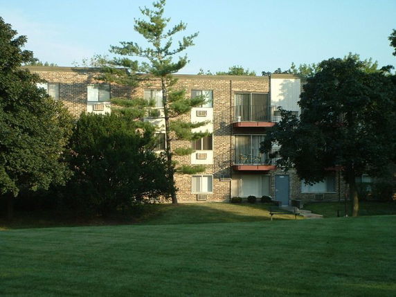 Front view of a multi-story apartment building with balconies.