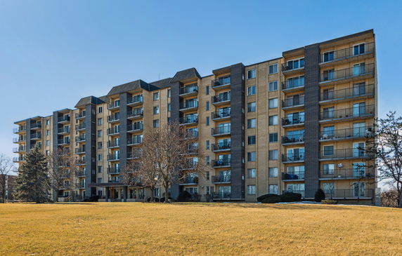 Front view of a multi-story apartment building with balconies.