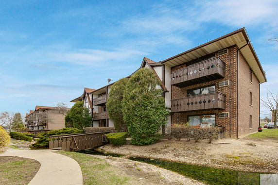 Front view of a multi-story residential building with balconies.
