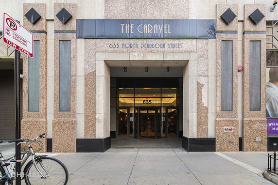 Front view of a building with a prominent entrance and glass doors.