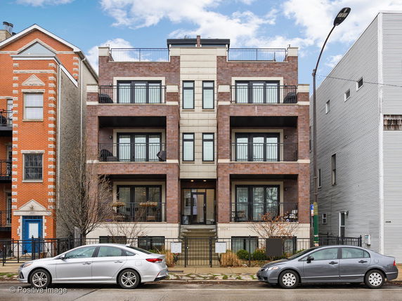 Front view of a multi-story residential building with balconies.