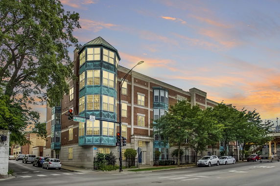 Front view of a multi-story building with distinctive glass and brick architecture.