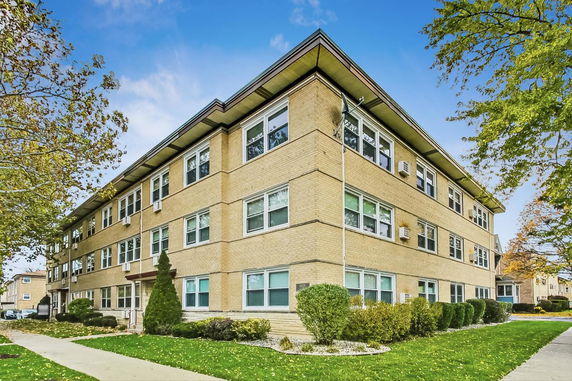 Front view of a three-story brick apartment building.