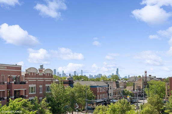 Panoramic view of cityscape with buildings and skyline in the distance.