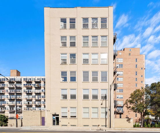 Front view of a multi-story building with numerous windows.