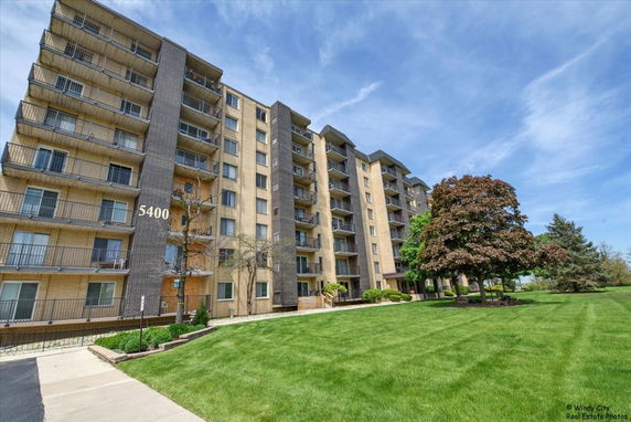 Front view of a multi-story apartment building with balconies.
