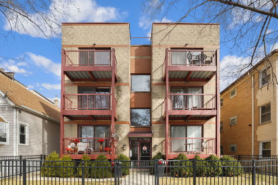 Front view of a multi-story residential building with balconies.