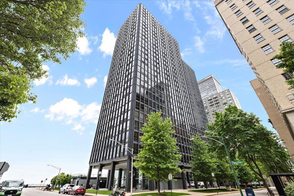 View of a tall, multi-story office building with a modern glass facade.