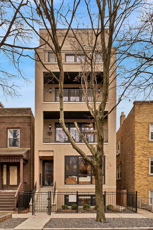 Front view of a modern multi-story building with balconies.