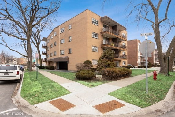 Front view of a multi-story apartment building with balconies.