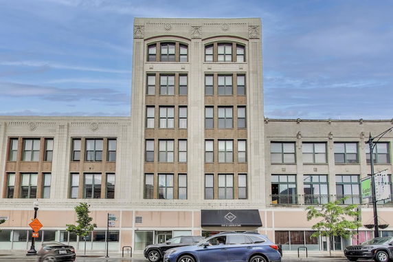 Front view of a multi-story commercial building with decorative elements.