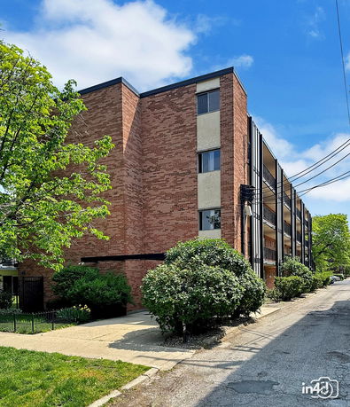 Front view of a multi-story brick apartment building.