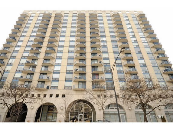 Front view of a high-rise residential building with balconies.