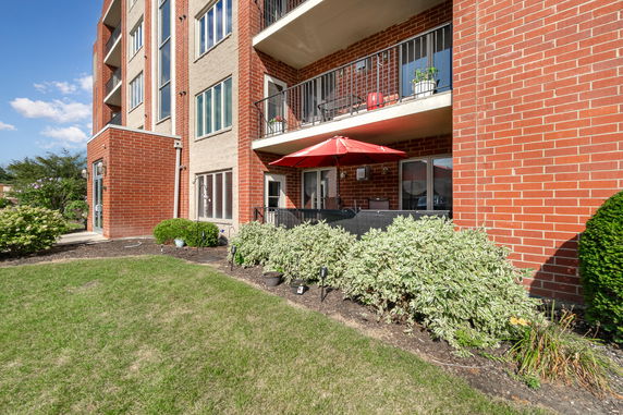 Facade of a residential building with balconies and a red brick exterior.