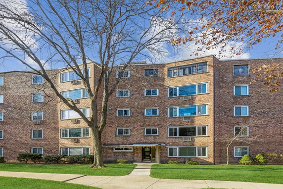 Front view of a multi-story brick apartment building.