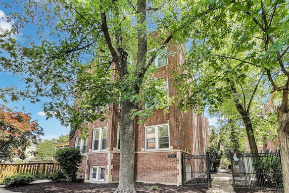 Front view of a multi-story brick apartment building.