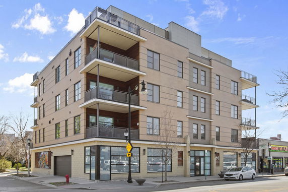 Front view of a multi-story building with balconies.