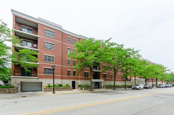 Front view of a multi-story brick apartment building.